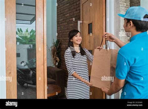 Delivery Man Delivering Food To A Man At Home Online Food Shopping Delivery Man Delivering Food To A Man At Home Online Food Shopping